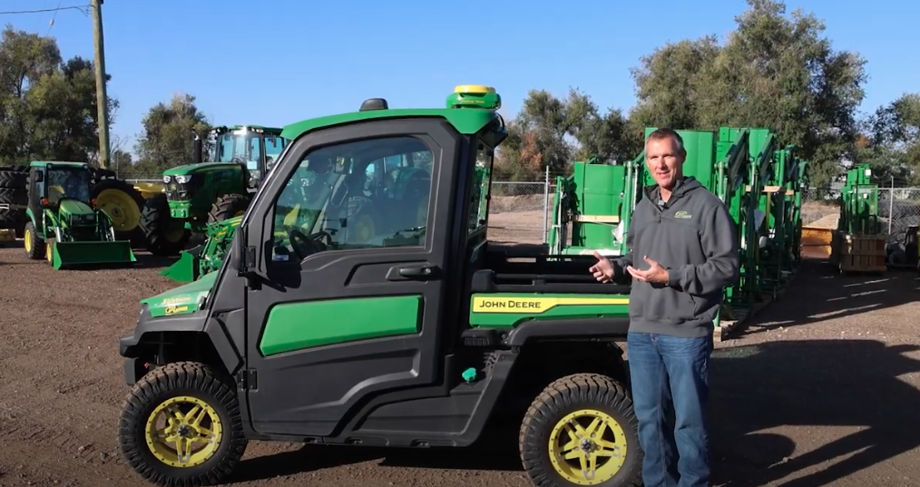 Mike Wemhoff standing beside a John Deere Gator.